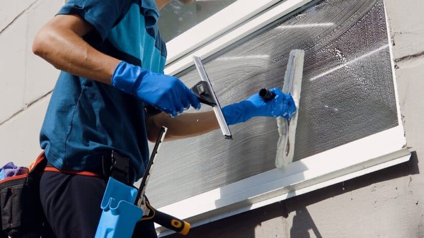 Photo of a man cleaning window